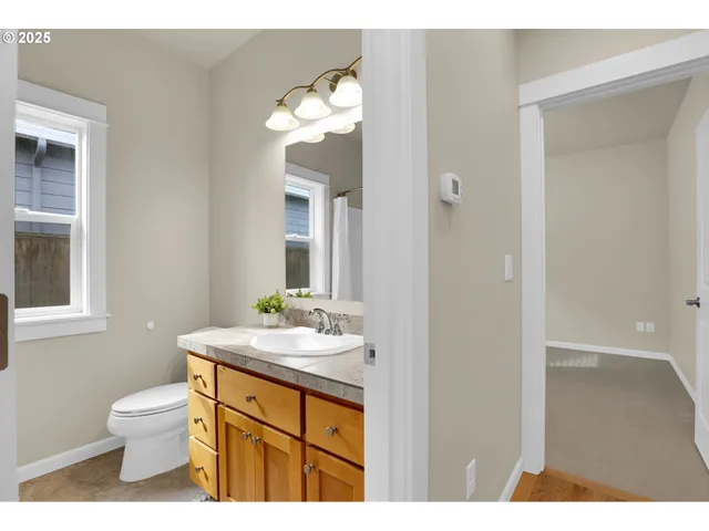 a bathroom with a sink a toilet and mirror