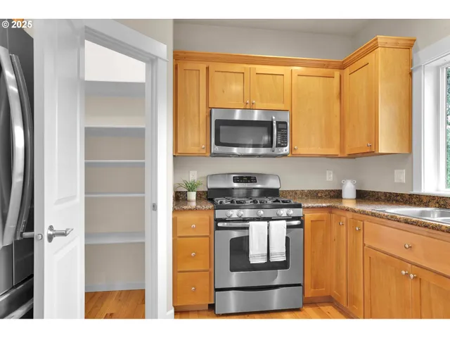 a kitchen with a stove microwave and sink