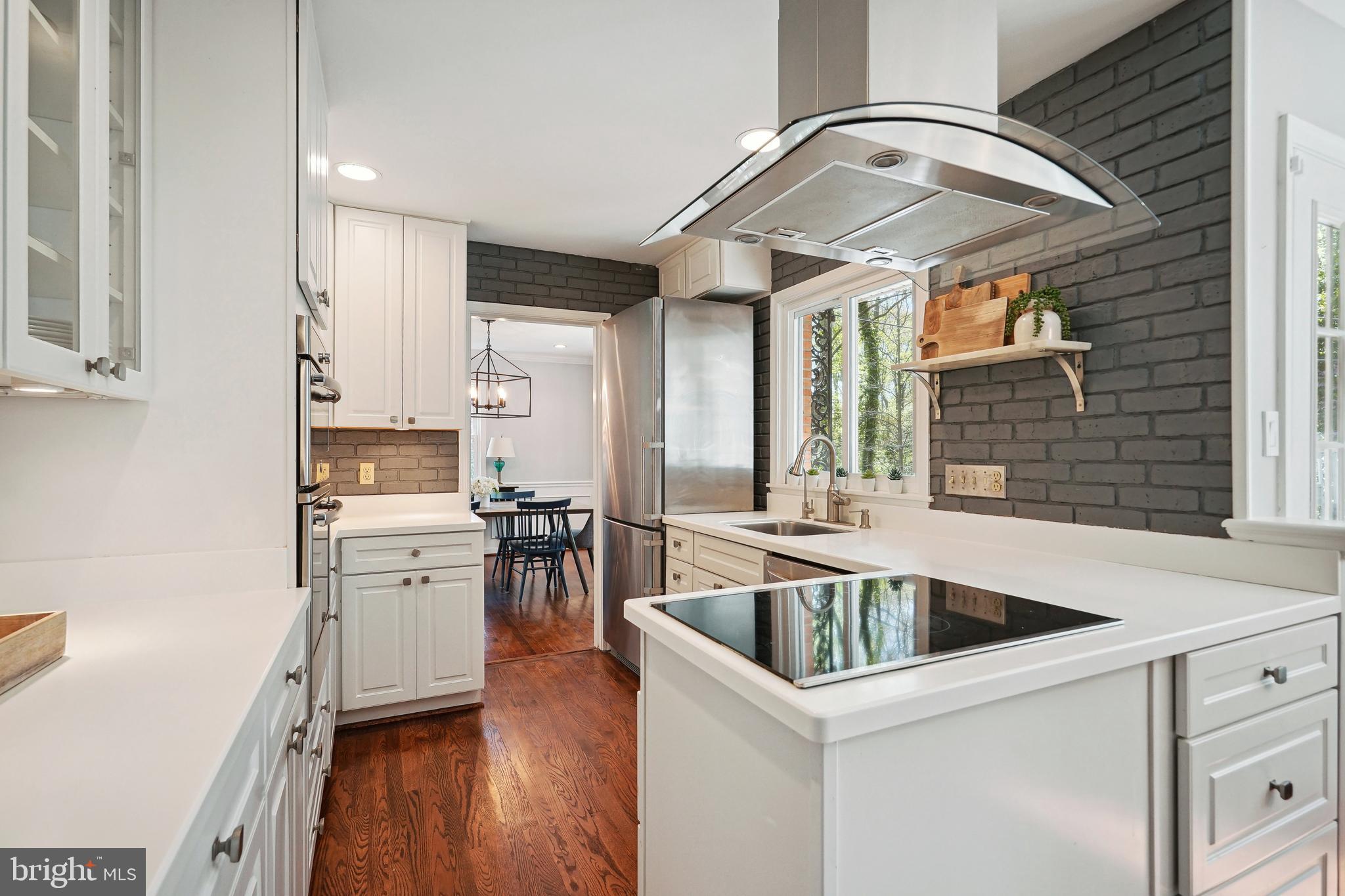 8504 Stable Drive Alexandria, VA 22308 - Photo 13 of 53 White Cabinetry and Stainless Steel Appliances