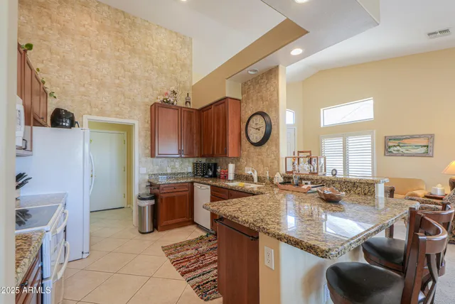 a large kitchen with lots of counter top space and stainless steel appliances