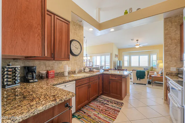 a kitchen with stainless steel appliances granite countertop a sink stove and cabinets