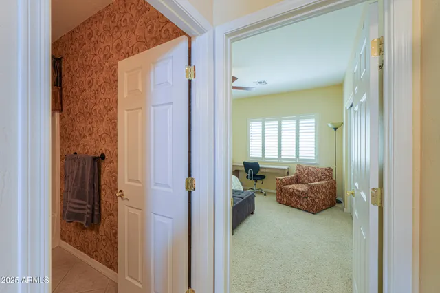 a bedroom with a bed couch and window