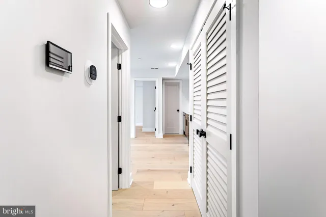 a view of a hallway with wooden floor and entryway