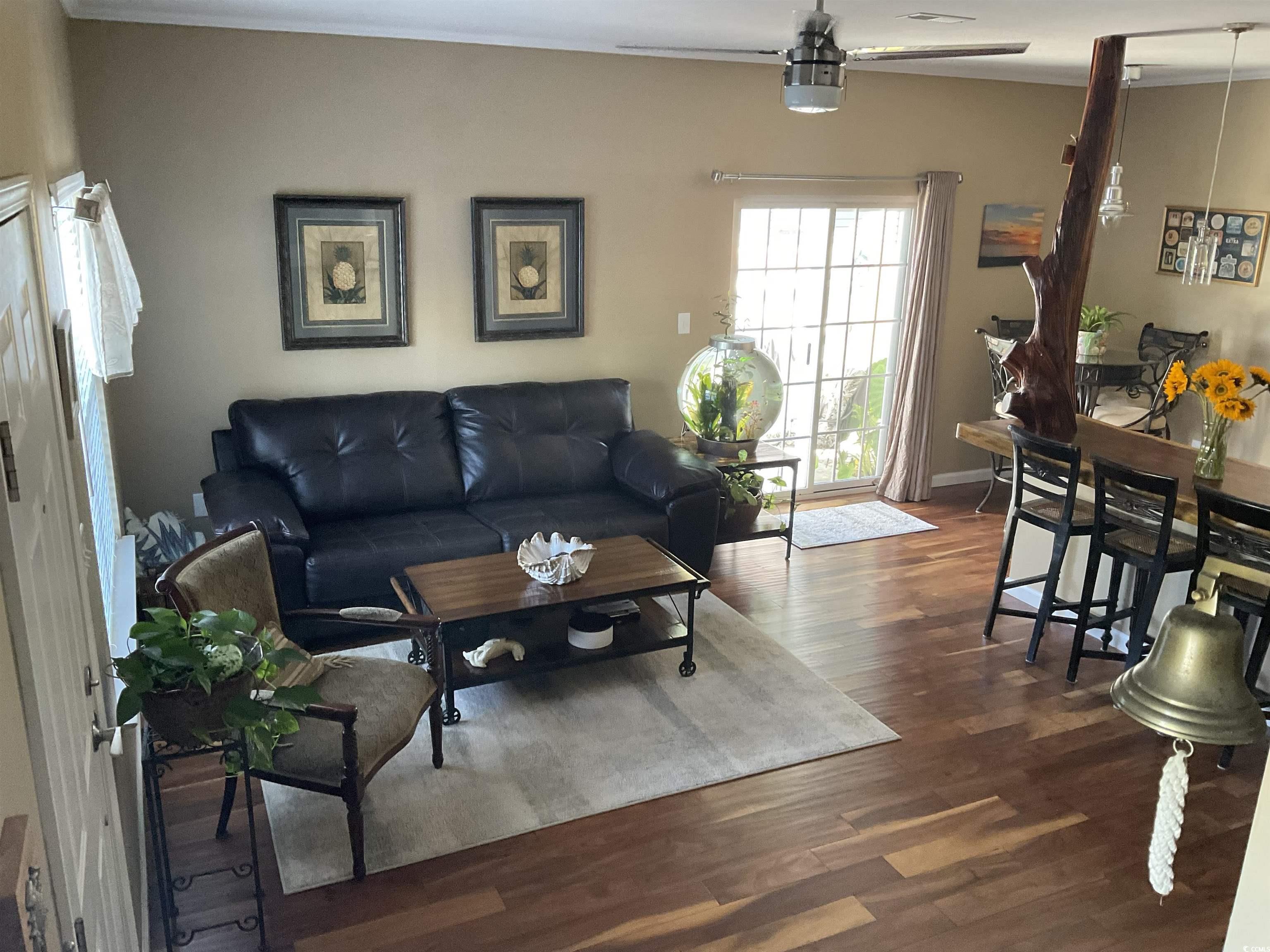804 Brenda Place Myrtle Beach, SC 29577 - Photo 4 of 39 Living area with dark wood-type flooring and ornamental molding