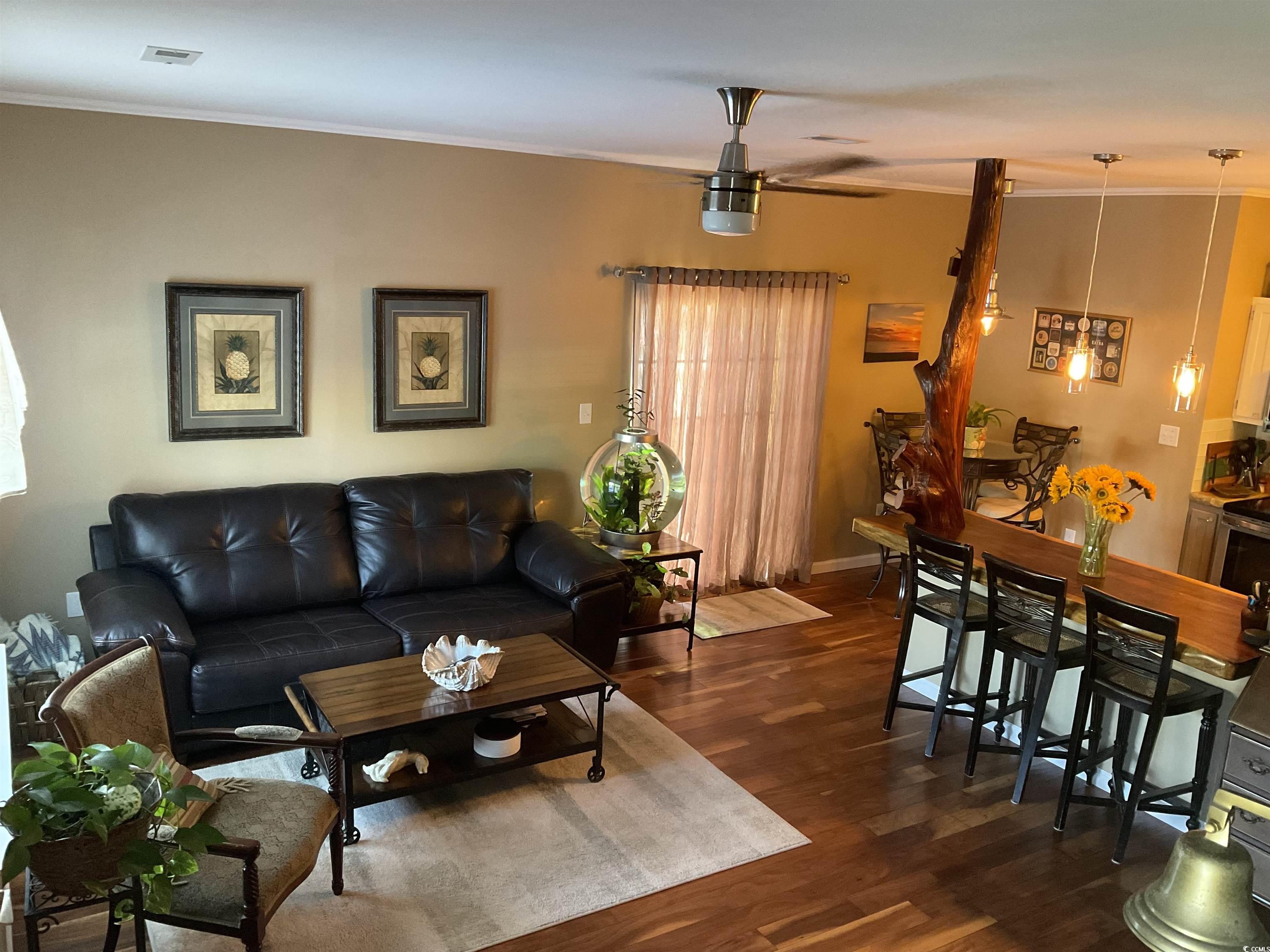 804 Brenda Place Myrtle Beach, SC 29577 - Photo 6 of 39 Living area with ornamental molding, dark wood-type flooring, and ceiling fan