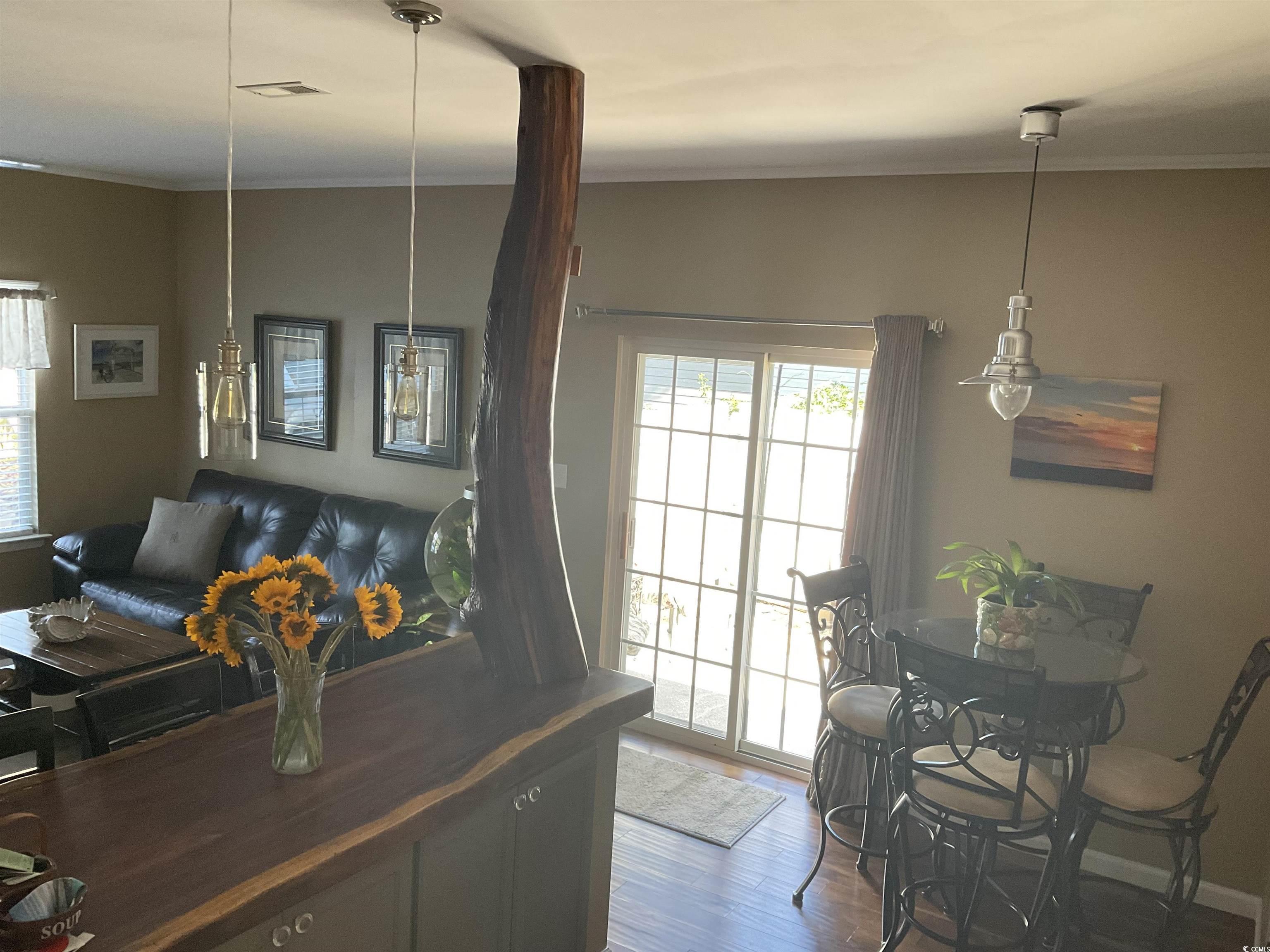 804 Brenda Place Myrtle Beach, SC 29577 - Photo 7 of 39 Dining room with healthy amount of natural light, crown molding, and wood finished floors
