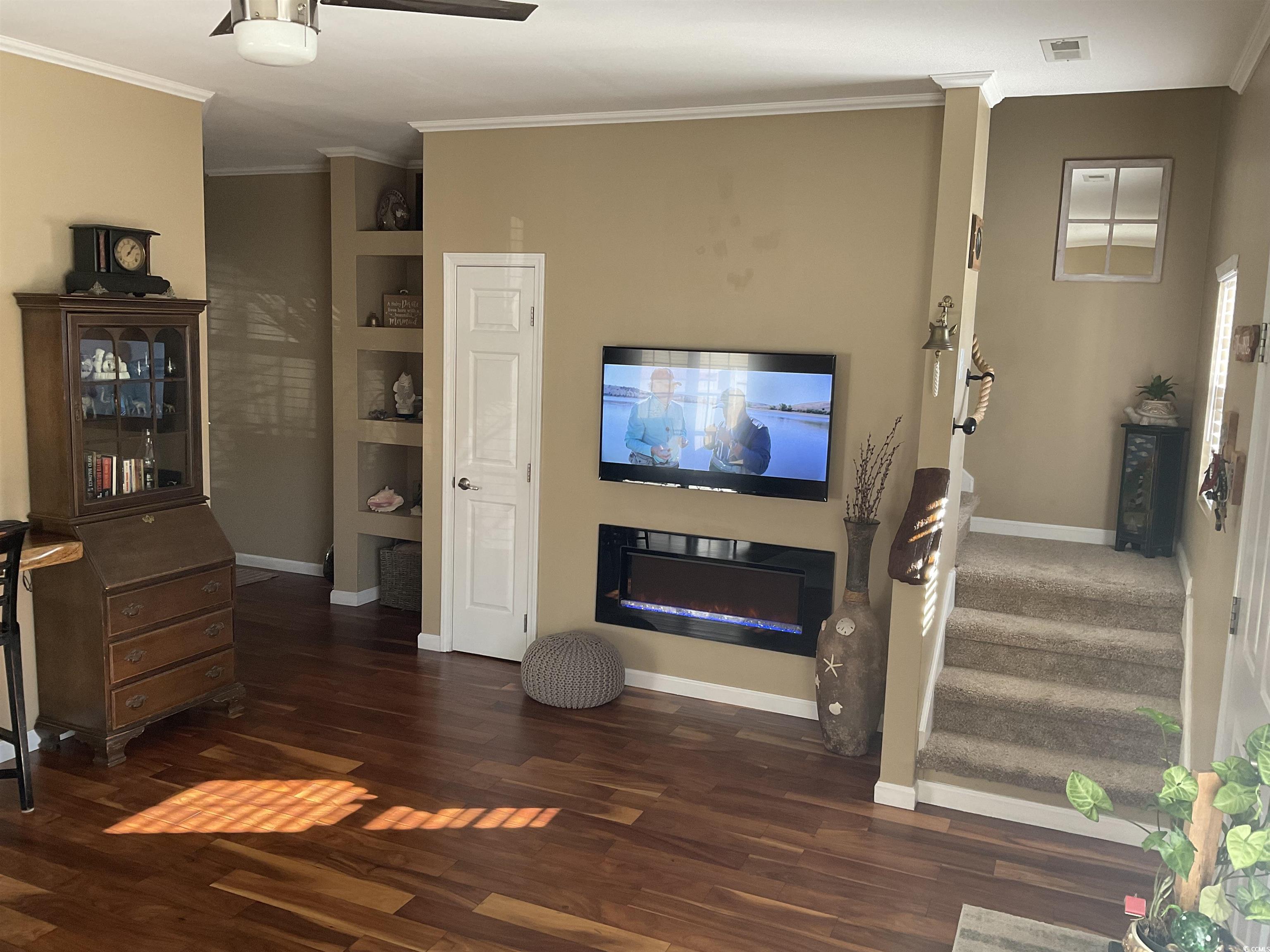 804 Brenda Place Myrtle Beach, SC 29577 - Photo 10 of 39 Living room with crown molding and dark wood-type flooring