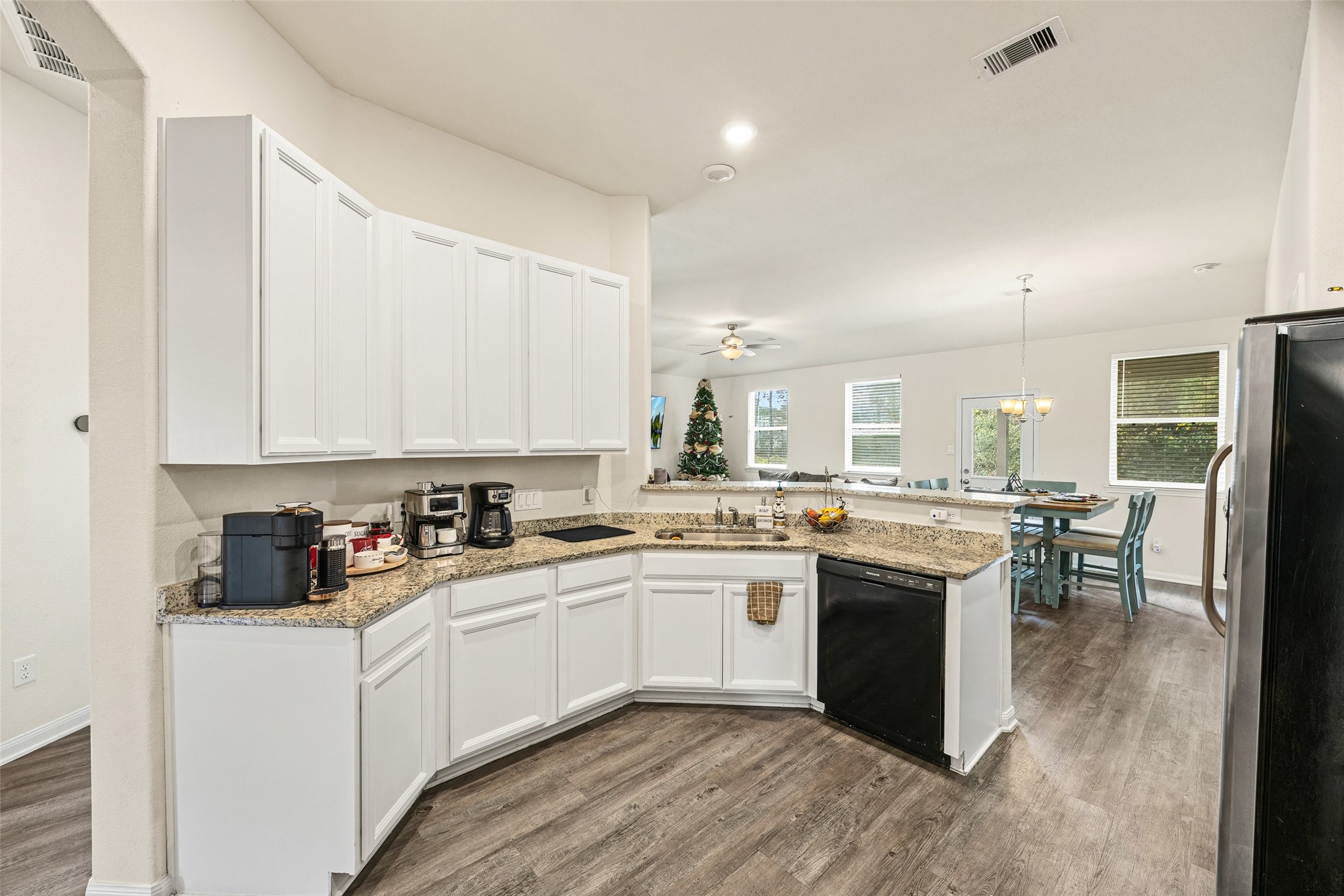 156 County Road Cleveland, TX 77327 - Photo 16 of 26 a kitchen with white cabinets sink and dining table chair