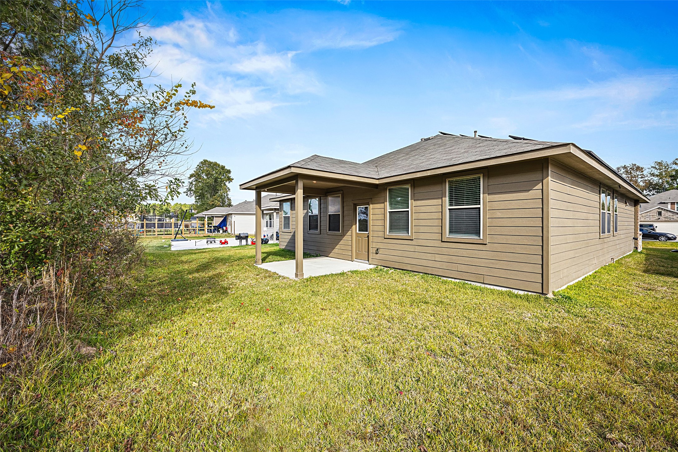 156 County Road Cleveland, TX 77327 - Photo 24 of 26 a backyard of a house with lots of green space