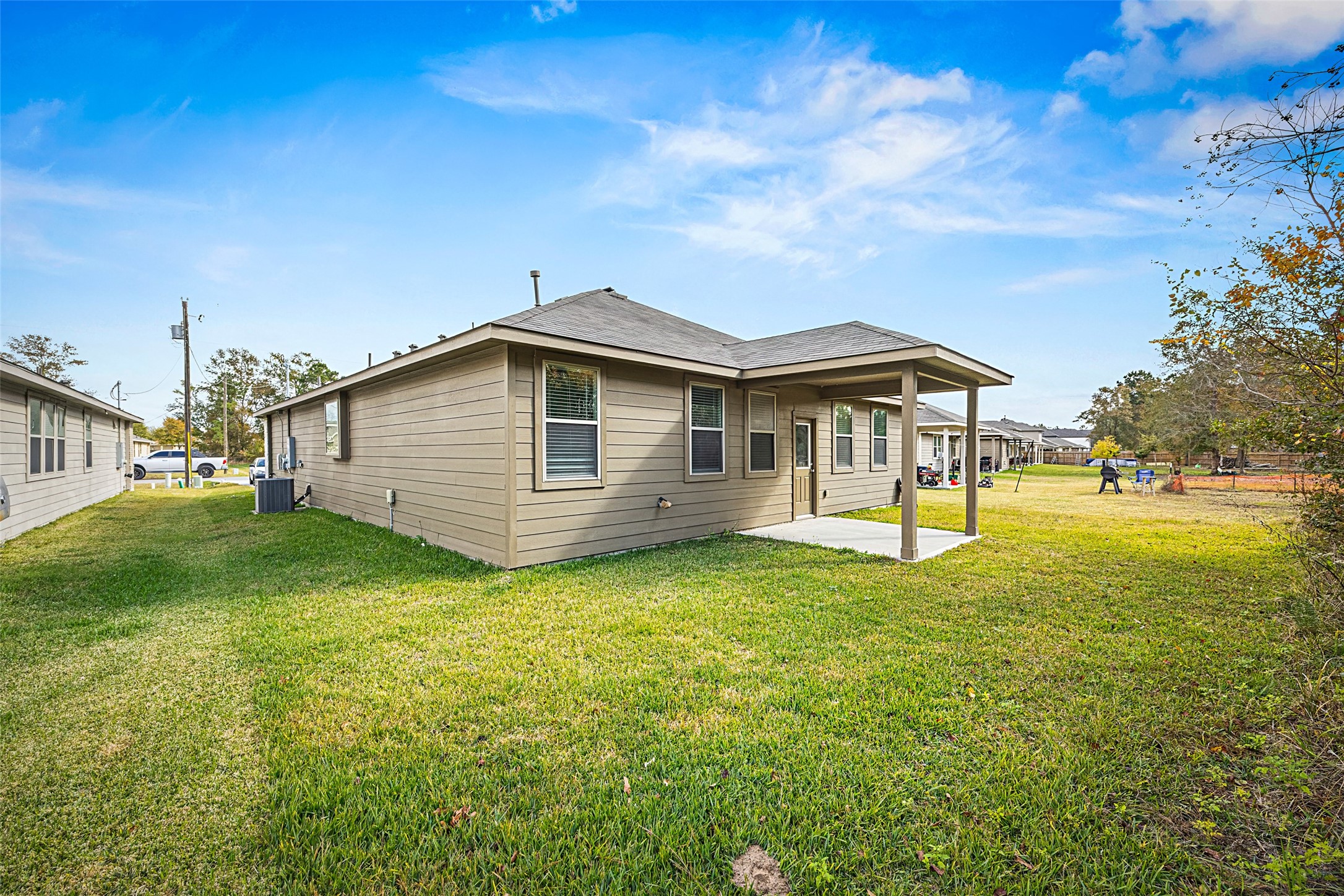 156 County Road Cleveland, TX 77327 - Photo 25 of 26 a view of a house with a backyard