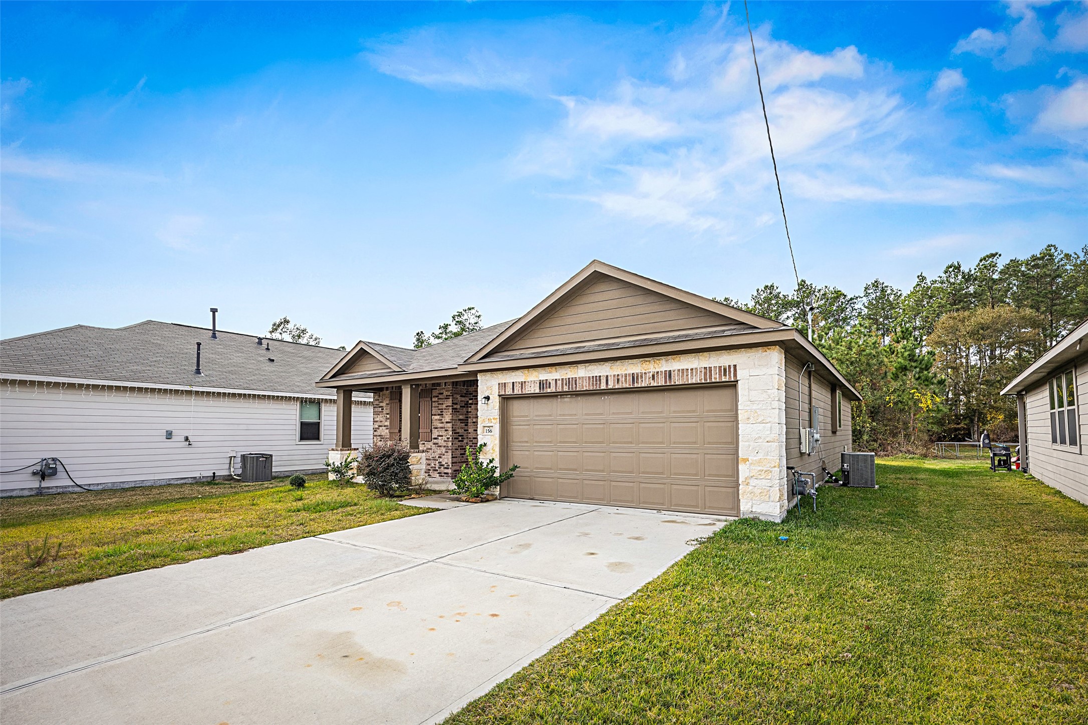 156 County Road Cleveland, TX 77327 - Photo 3 of 26 a front view of a house with a yard