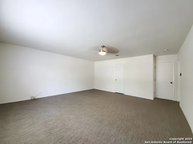 an empty room with a kitchen