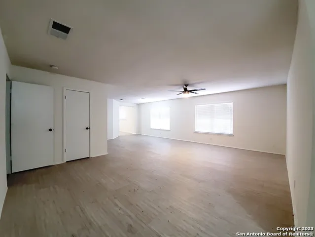 a view of a livingroom with a ceiling fan and window