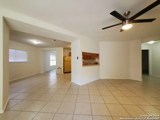 a view of an empty room and a window
