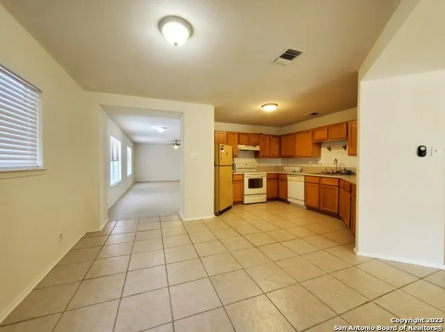 a view of a kitchen with a sink and a refrigerator