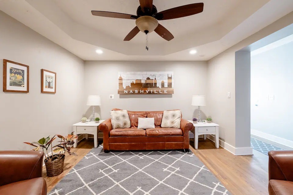 a living room with furniture a ceiling fan and a rug