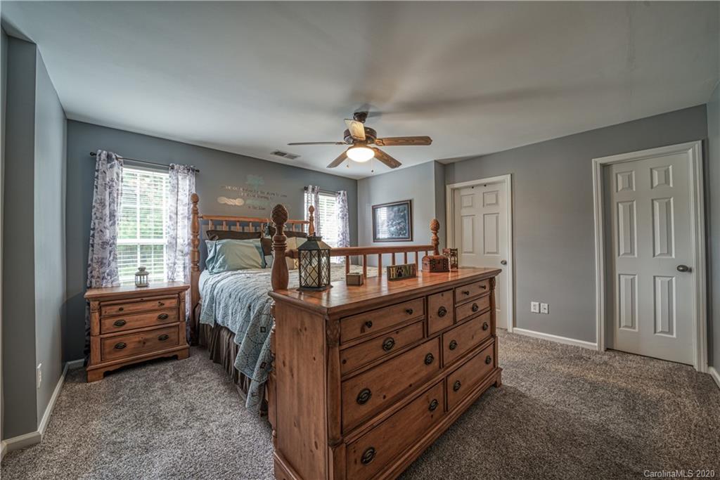 808 Dillard Road Rock Hill, SC 29730 - Photo 18 of 29 a bed room with a bed and a chandelier