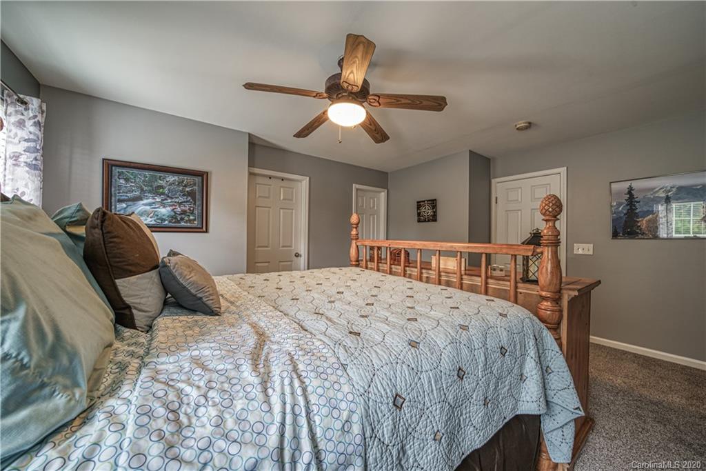 808 Dillard Road Rock Hill, SC 29730 - Photo 19 of 29 a bedroom with a bed a chandelier and dresser