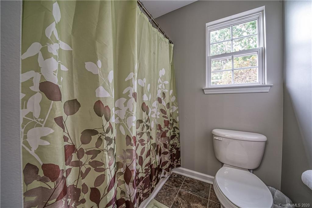 808 Dillard Road Rock Hill, SC 29730 - Photo 21 of 29 a bathroom with a toilet and a shower curtain
