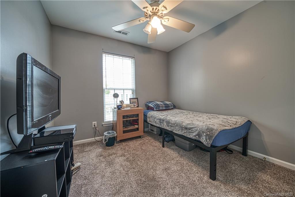 808 Dillard Road Rock Hill, SC 29730 - Photo 23 of 29 a bedroom with a bed and a flat screen tv