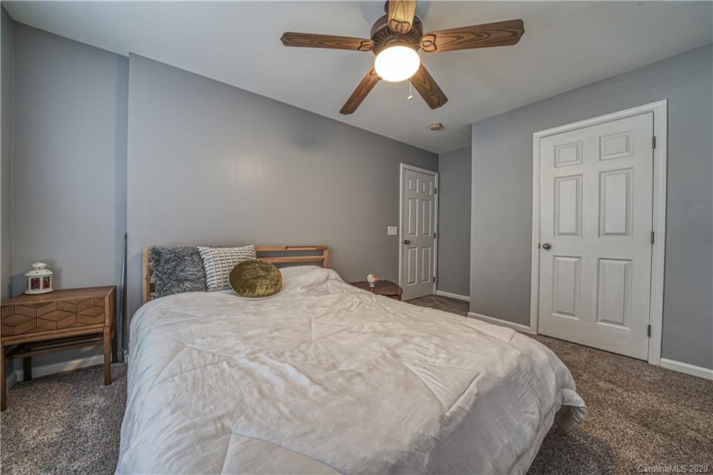 808 Dillard Road Rock Hill, SC 29730 - Photo 25 of 29 a bedroom with a bed and a chandelier