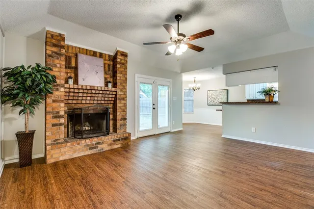 a view of a livingroom with a fireplace and window