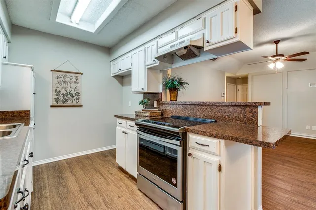 a kitchen with stainless steel appliances granite countertop a stove and a sink