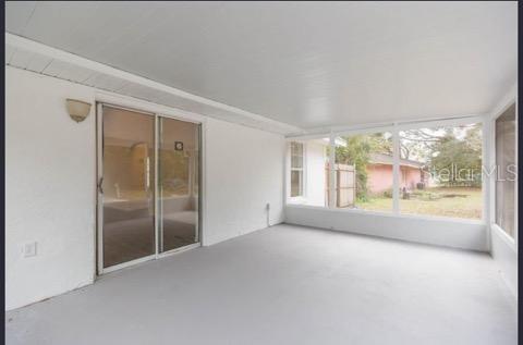 4 Cedar Trace Way Ocala, FL 34472 - Photo 13 of 36 an empty room with an outdoor view and a window