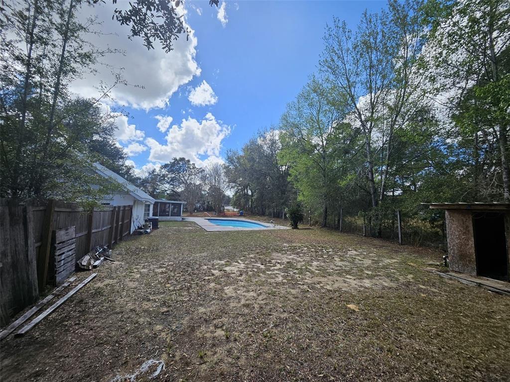4 Cedar Trace Way Ocala, FL 34472 - Photo 16 of 36 a view of a backyard with large trees