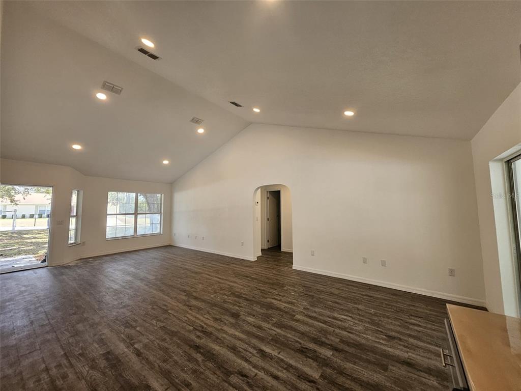 4 Cedar Trace Way Ocala, FL 34472 - Photo 20 of 36 an empty room with wooden floor and windows