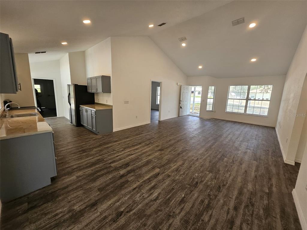 4 Cedar Trace Way Ocala, FL 34472 - Photo 21 of 36 an empty room with wooden floor and windows