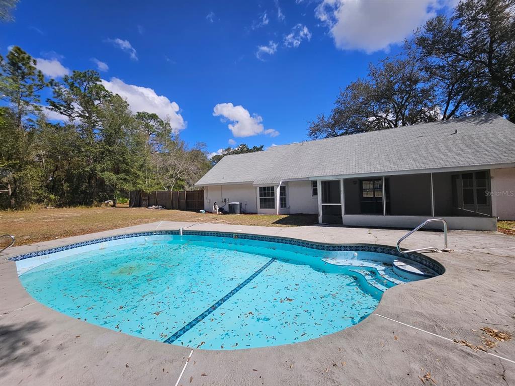 4 Cedar Trace Way Ocala, FL 34472 - Photo 22 of 36 a front view of a house with a yard