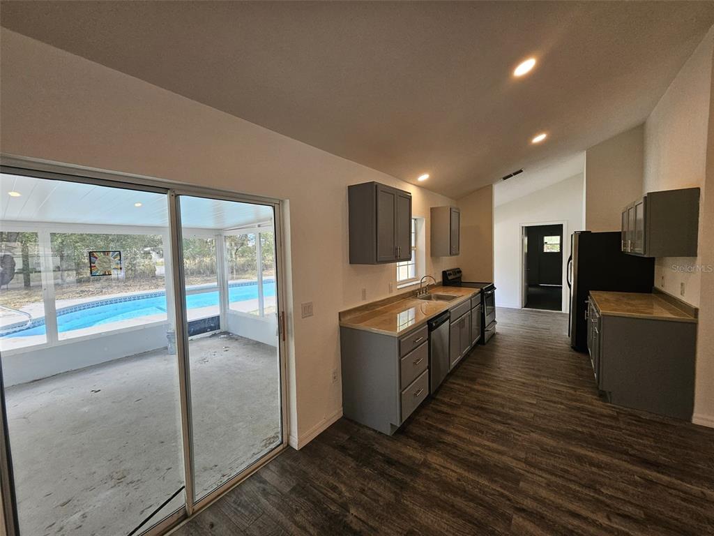 4 Cedar Trace Way Ocala, FL 34472 - Photo 23 of 36 a large space with a large window and wooden floor