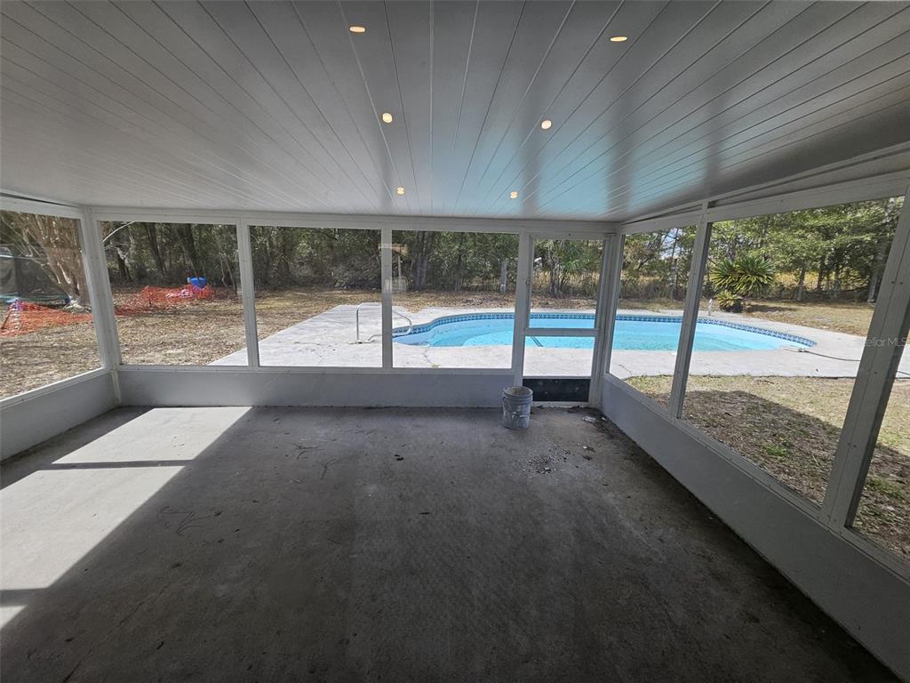 4 Cedar Trace Way Ocala, FL 34472 - Photo 24 of 36 a view of an empty room with wooden floor and a floor to ceiling window