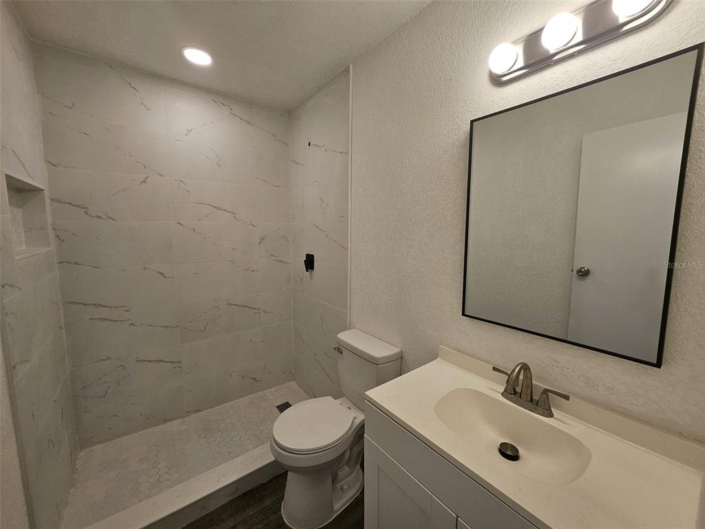 4 Cedar Trace Way Ocala, FL 34472 - Photo 30 of 36 a bathroom with a sink mirror toilet and shower