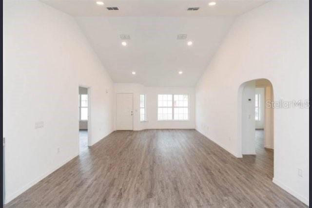 4 Cedar Trace Way Ocala, FL 34472 - Photo 5 of 36 an empty room with wooden floor and windows