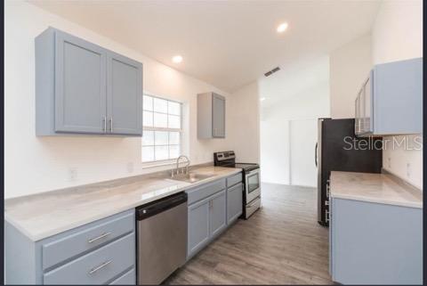 4 Cedar Trace Way Ocala, FL 34472 - Photo 7 of 36 a kitchen with a sink appliances and cabinets
