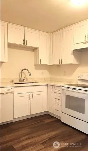 a view of a kitchen with sink and cabinets