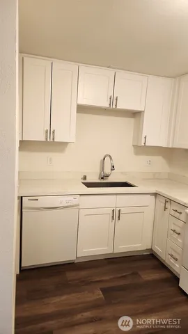 a kitchen with a sink cabinets and a window