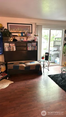 a living room with furniture a window and dresser
