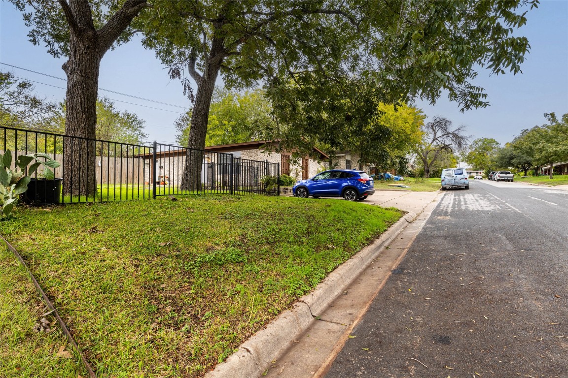1411 Braes Ridge Drive, Unit B Austin, TX 78723 - Photo 3 of 37 a view of a garden with a bench