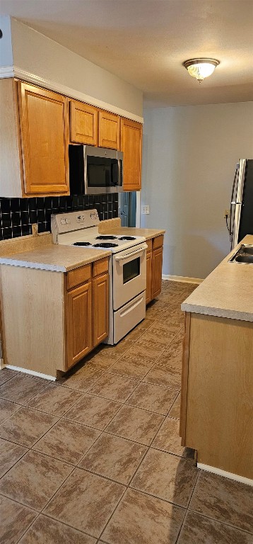 1411 Braes Ridge Drive, Unit B Austin, TX 78723 - Photo 34 of 37 a kitchen with stainless steel appliances a stove a microwave and a sink