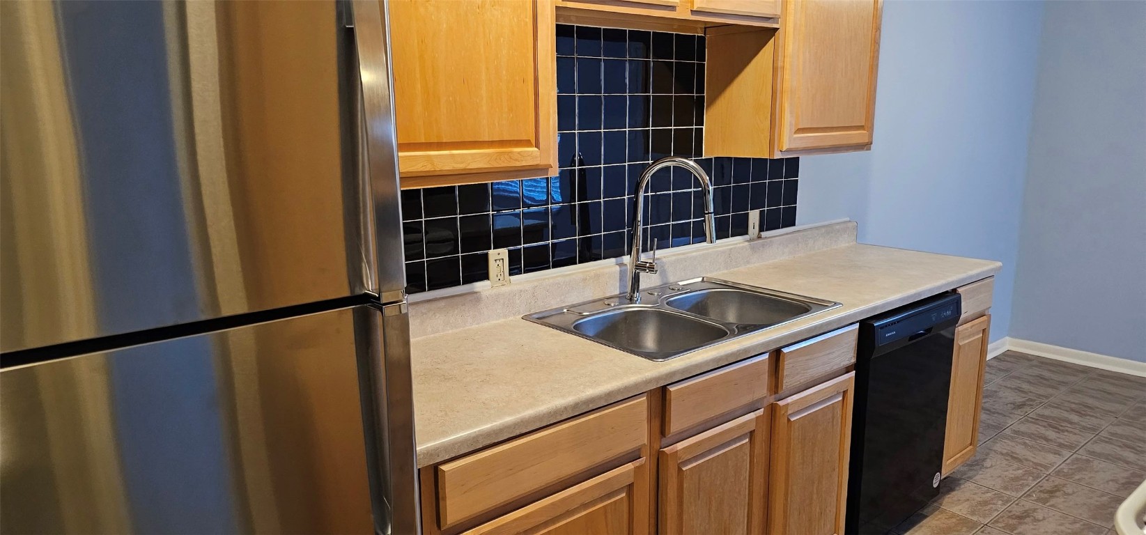 1411 Braes Ridge Drive, Unit B Austin, TX 78723 - Photo 35 of 37 a kitchen with a sink a refrigerator and cabinets