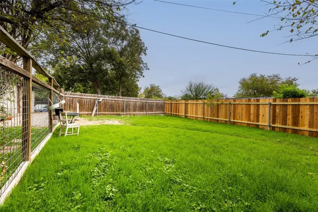 a view of yard with grass and trees