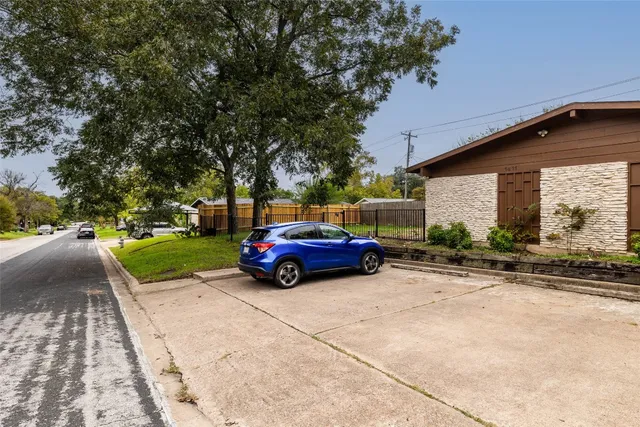 a view of a car parked in front of a house