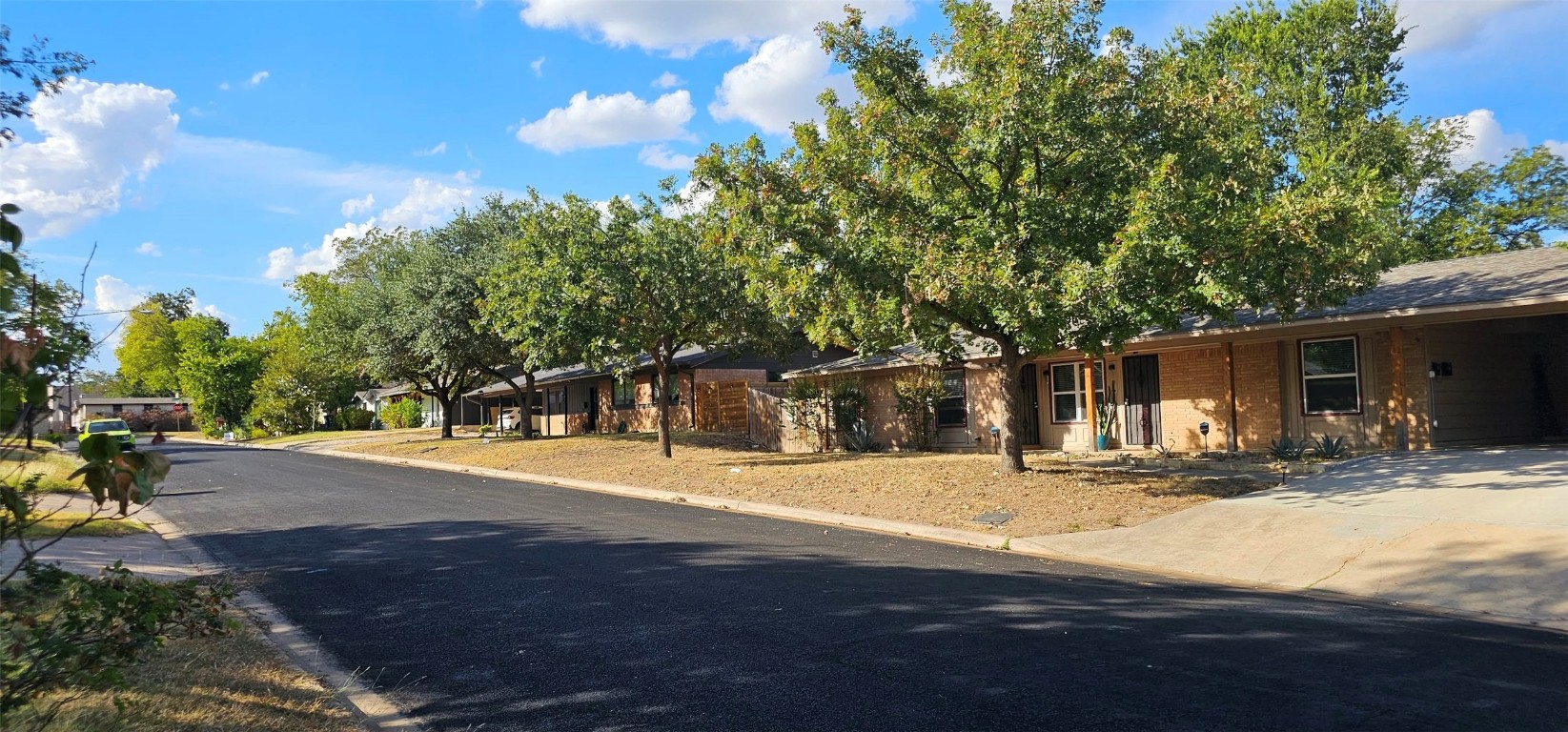 1411 Braes Ridge Drive, Unit B Austin, TX 78723 - Photo 10 of 37 a front view of a house with a yard and garage