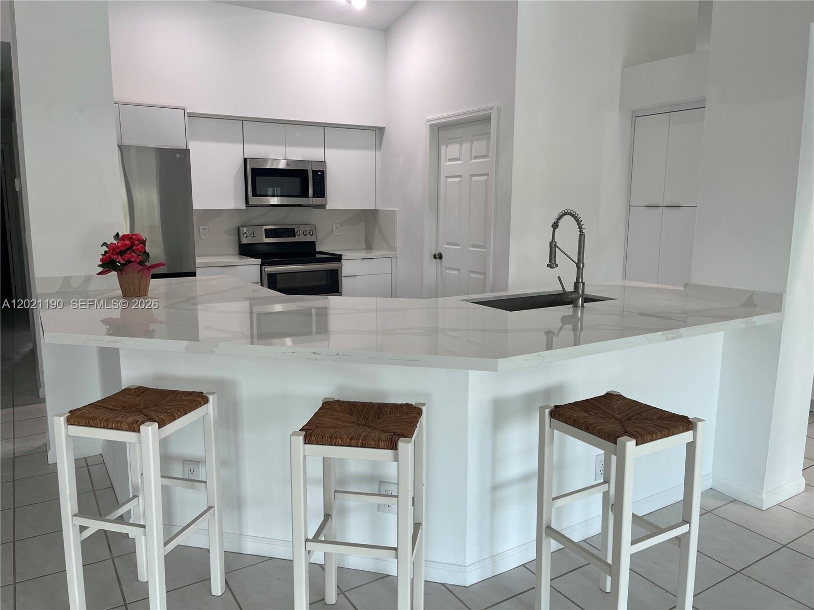 814 Heron Road Weston, FL 33326 - Photo 18 of 27 a kitchen with stainless steel appliances granite countertop a sink and microwave