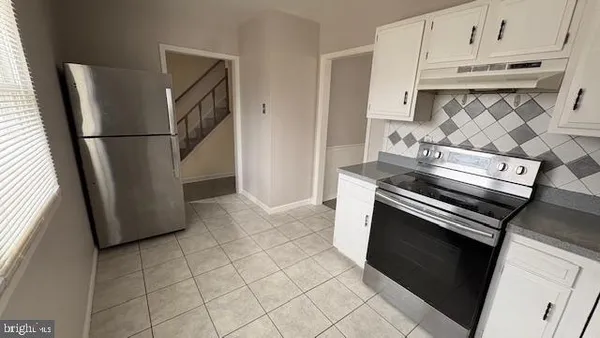 a kitchen with appliances and cabinets