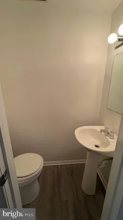a bathroom with a toilet a sink and a mirror