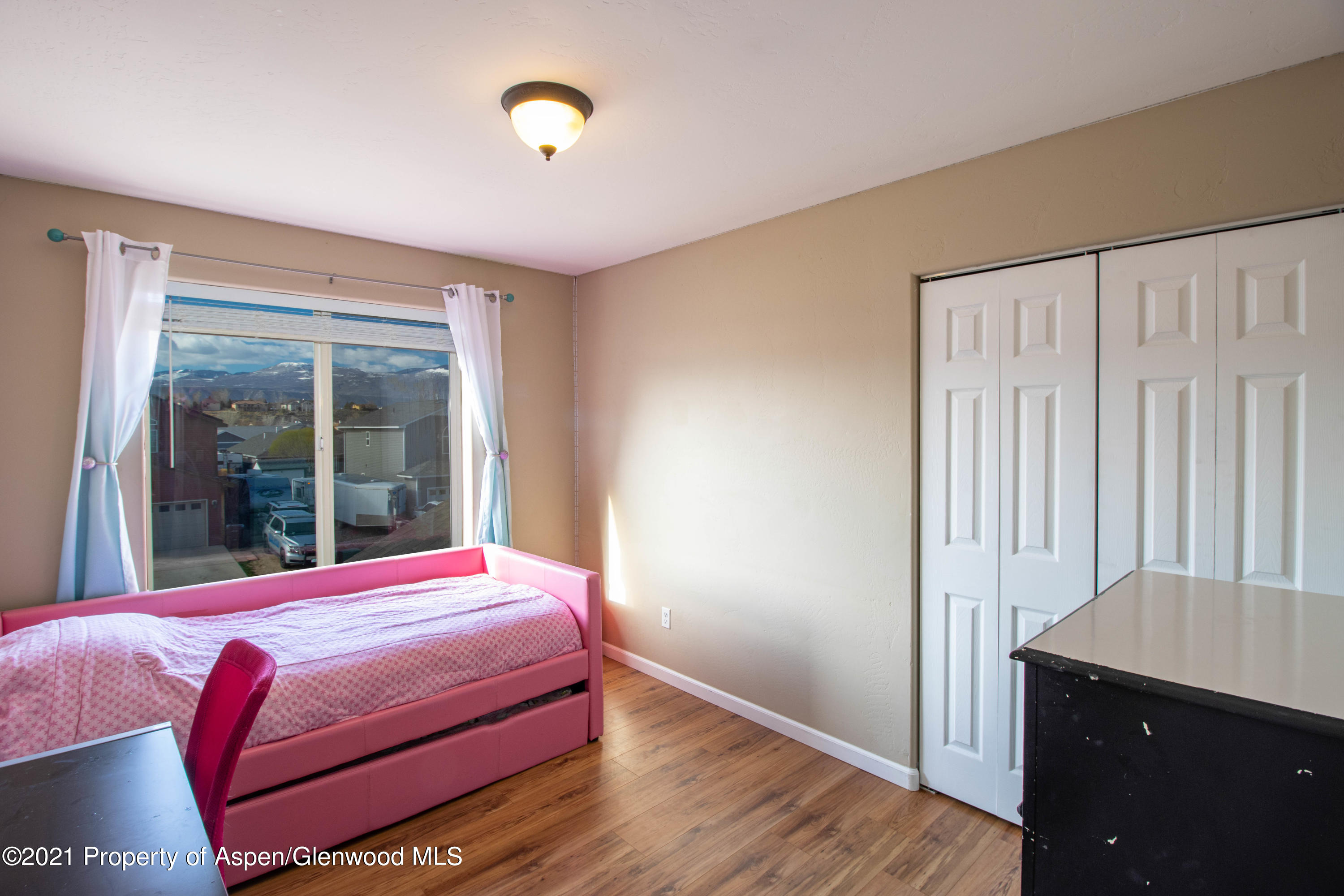 1280 East 18th Way Rifle, CO 81650 - Photo 12 of 18 a bedroom with a bed and a window